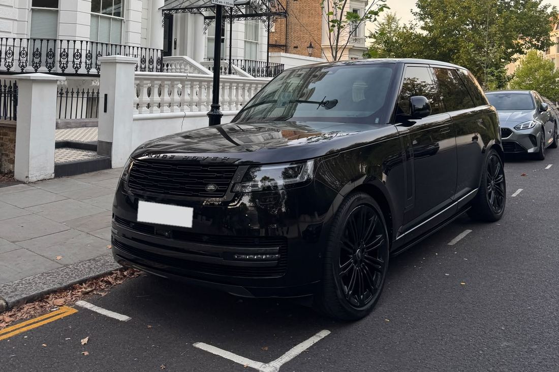 Black Range Rover on a white stucco street in London